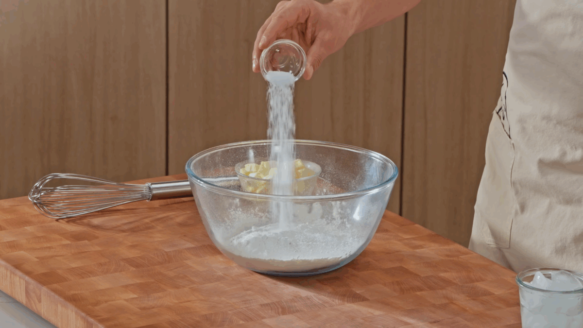 Nick DiGiovanni combining dry all-butter pie crust ingredients in a bowl.