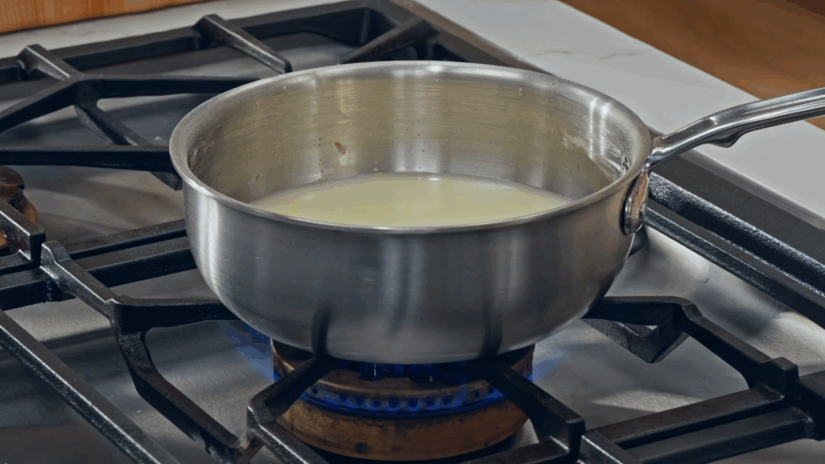 Nick DiGiovanni cooking a sugar syrup for lemon filling on the stovetop.