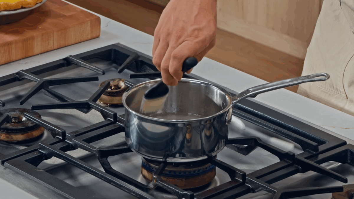 Nick DiGiovanni cooking sugar syrup in a saucepan on the stovetop.