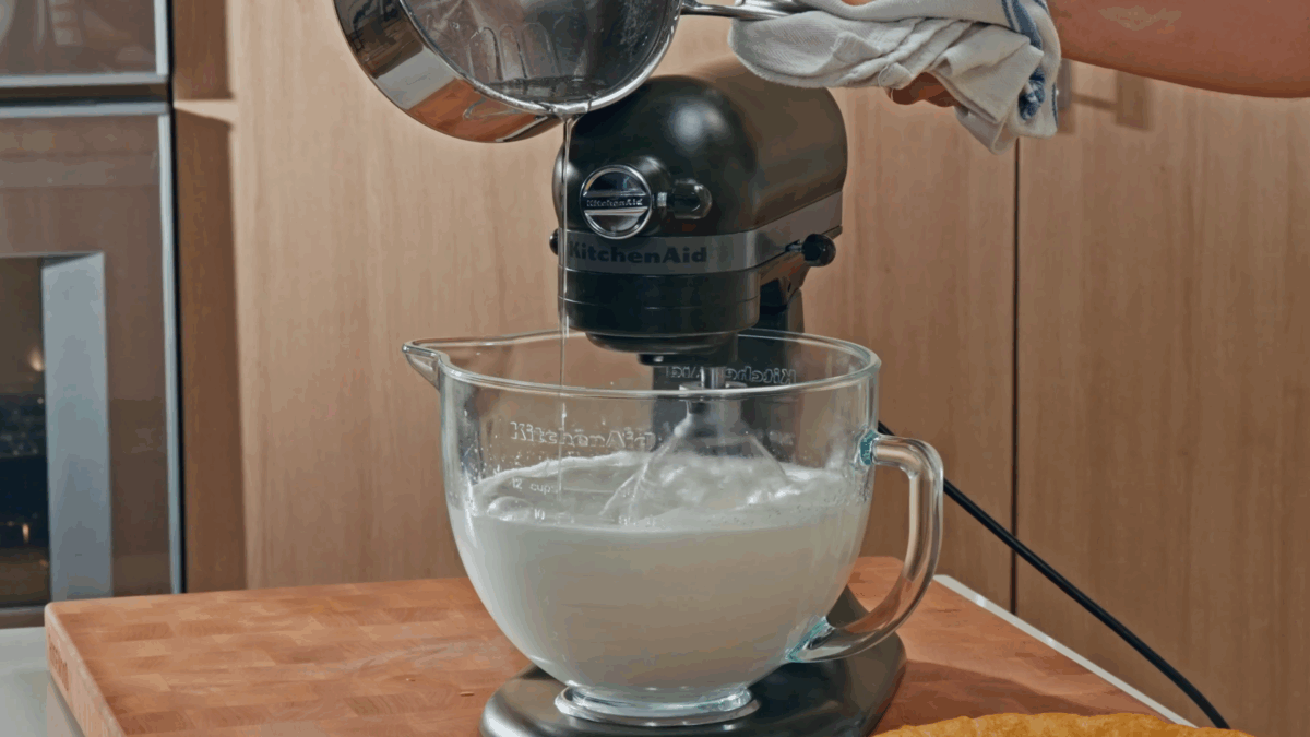 Nick DiGiovanni combining Italian meringue ingredients in a stand mixer.