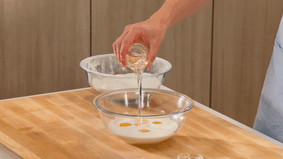 Nick DiGiovanni combining wet ingredients for a vanilla birthday cake recipe. 