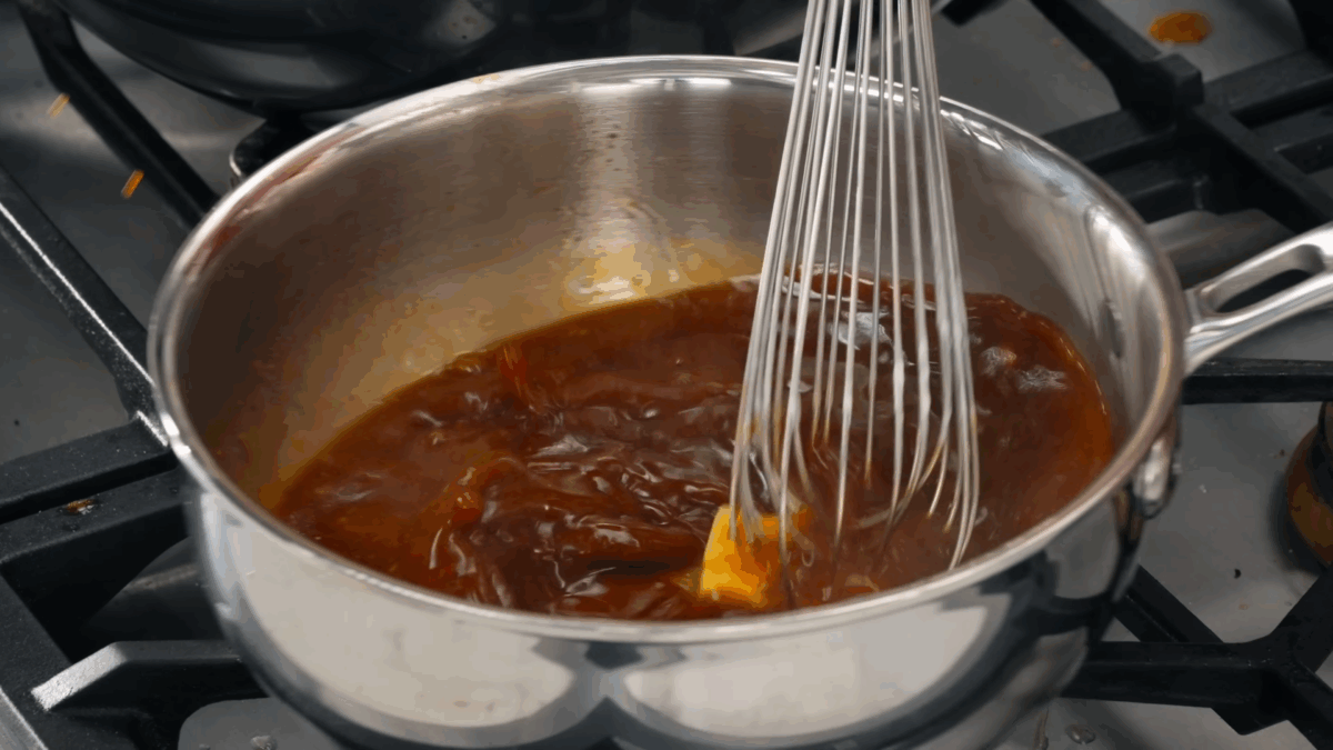 Nick DiGiovanni whisking butter into au jus.
