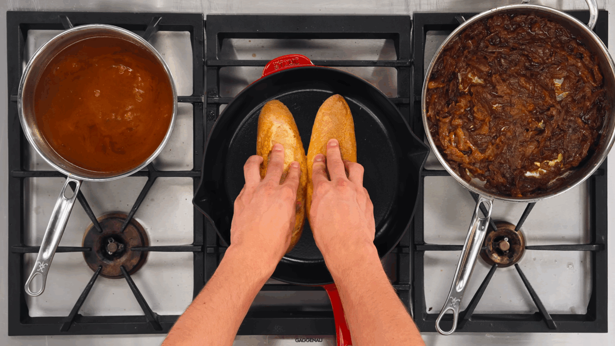 Nick DiGiovanni toasting two French baguette halves in a dry skillet.
