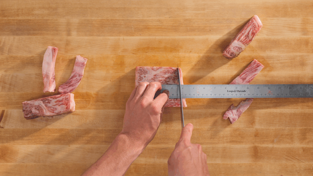 Nick DiGiovanni trimming raw Wagyu into a square. 