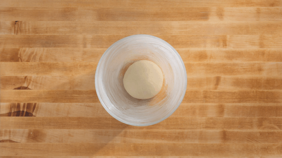 A ball of Japanese milk bread dough in a greased bowl. 