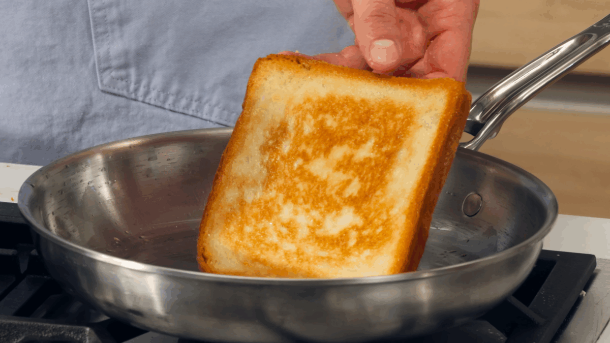 Nick DiGiovanni toasting a slice of shokupan in a skillet.  