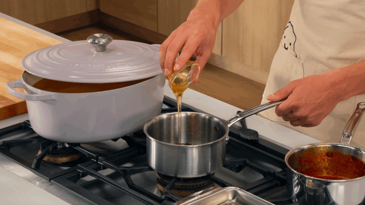 Nick DiGiovanni preparing soy garlic sauce in a pot.