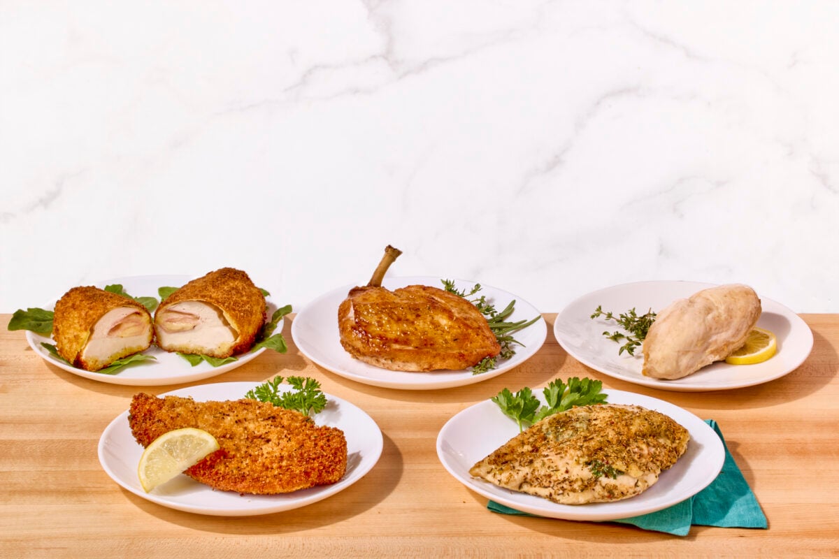 Five plates of chicken breasts prepared five different ways.