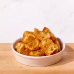 A bowl of crispy roasted potatoes.
