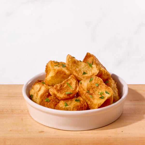 A bowl of crispy roasted potatoes.