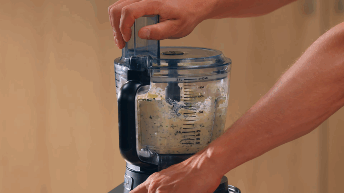 Nick DiGiovanni combining compound butter ingredients in a food processor.