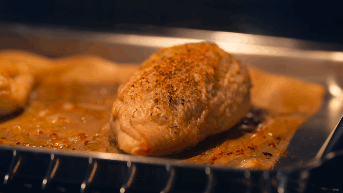 Chicken breasts baking in an oven.