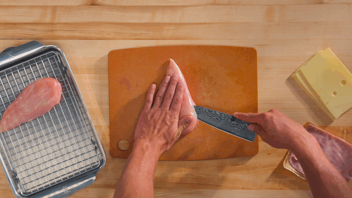 Nick DiGiovanni slicing a pocket into the side of a chicken breast.
