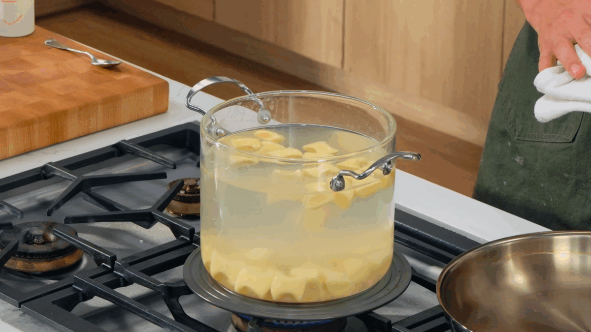Gnocchi pieces cooking in a pot of water. 