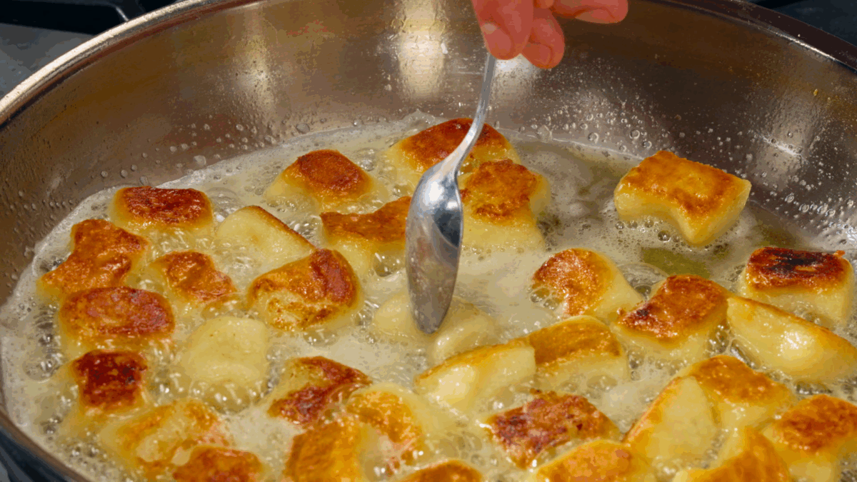Nick DiGiovanni crisping gnocchi pieces in a skillet. 