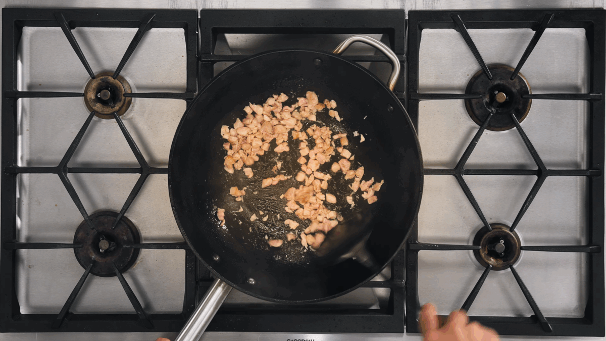 Nick DiGiovanni cooking chicken thigh pieces in a skillet. 