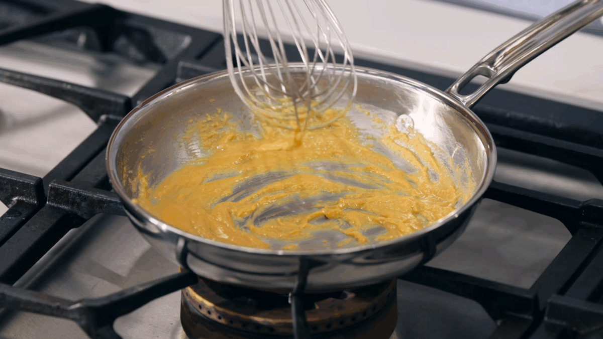 Nick DiGiovanni whisking a golden roux in a skillet. 