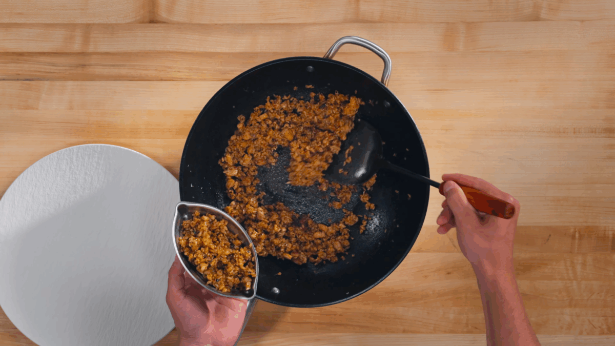 Nick DiGiovanni shaping chicken fried rice to plate omurice. 
