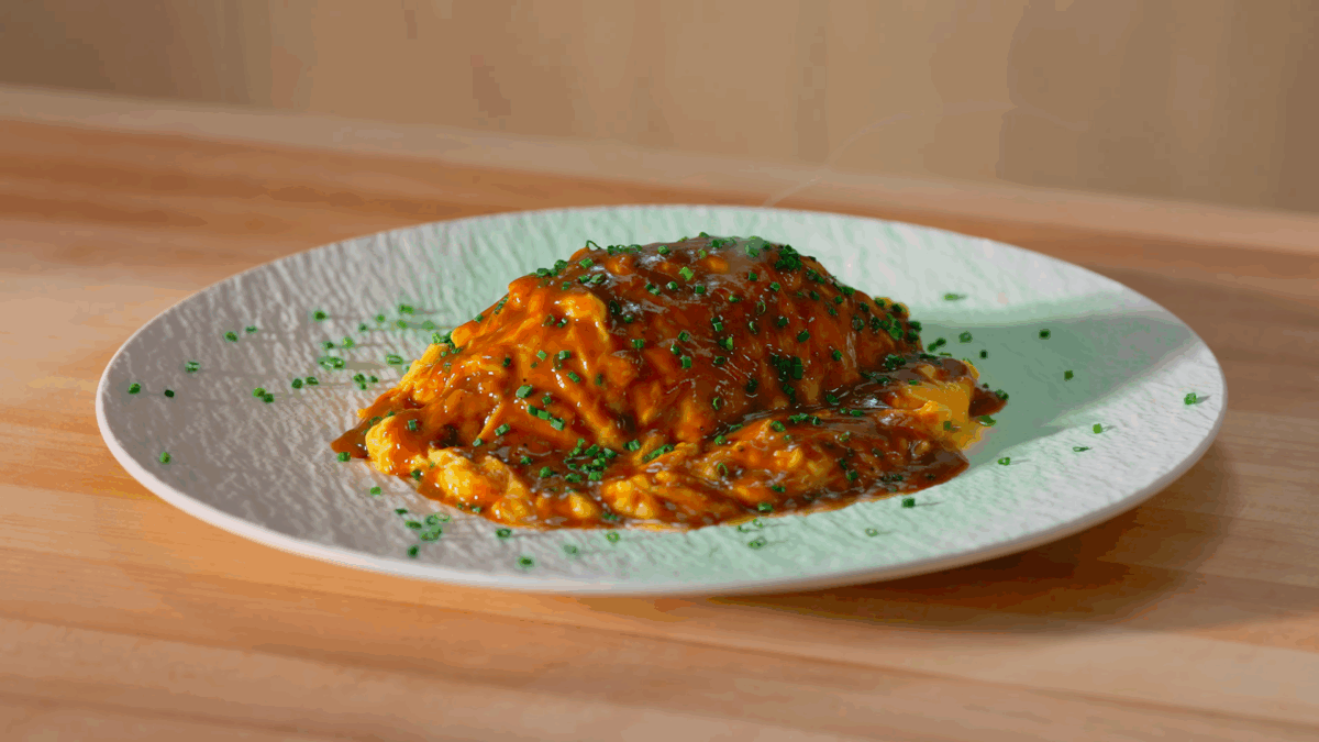A plate of Japanese Omurice with chicken fried rice, an omelet, and demi-glace. 