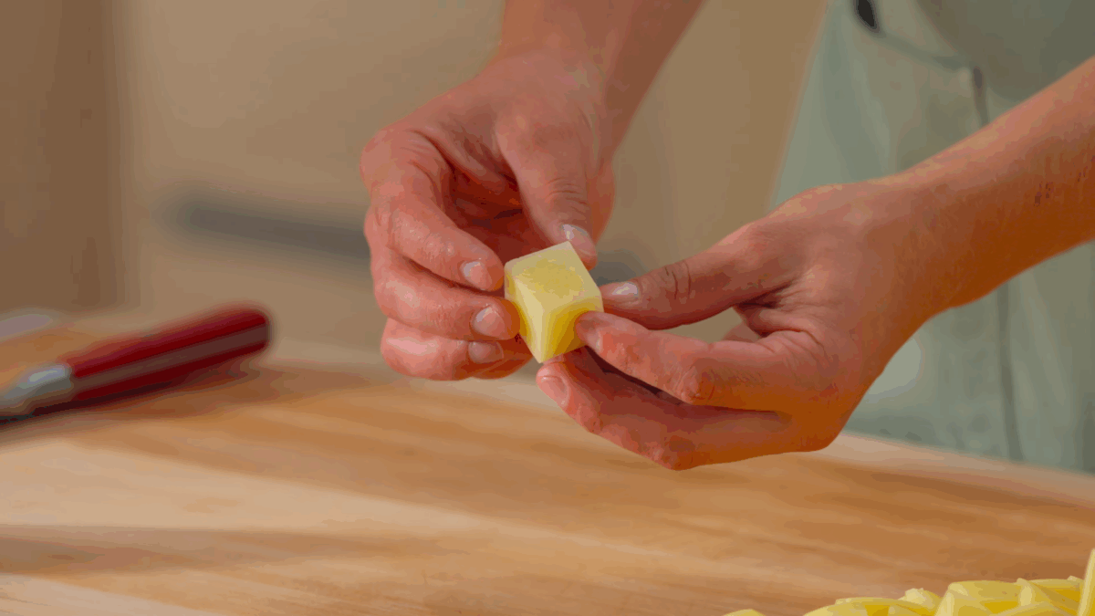 Nick DiGiovanni holding a Yukon Gold potato cube. 