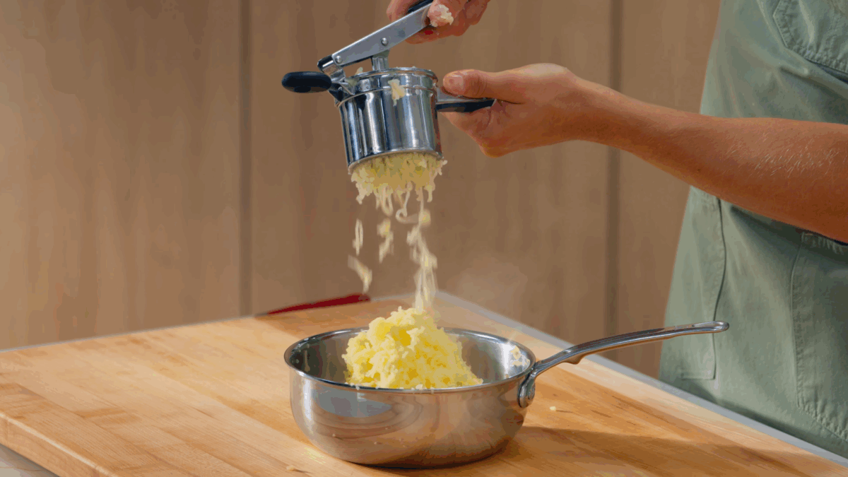 Nick DiGiovanni ricing boiled Yukon Gold potatoes.