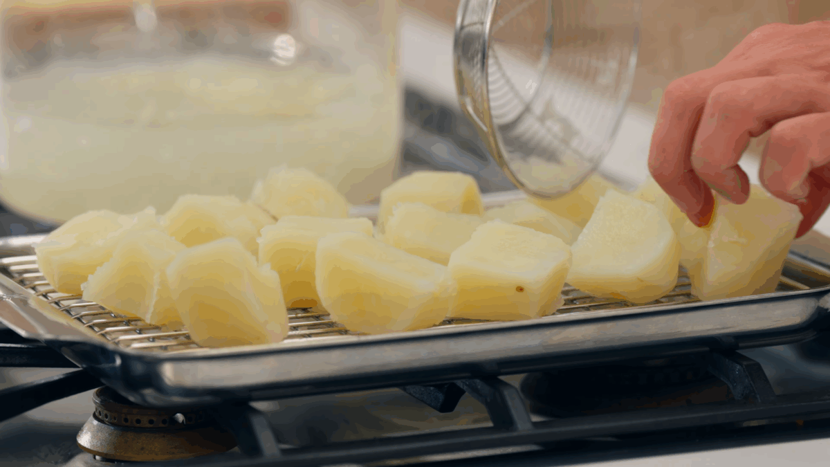 Nick DiGiovanni transferring boiled potatoes to a wire rack. 