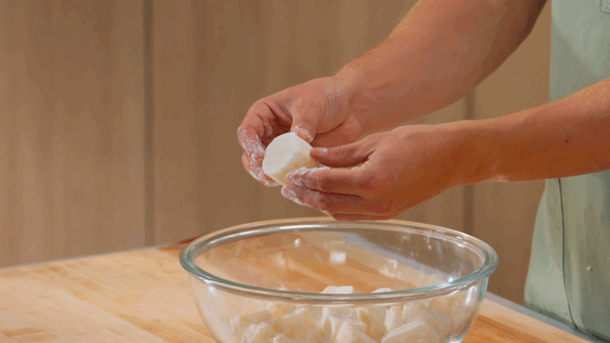 Nick DiGiovanni tossing potatoes in potato starch. 