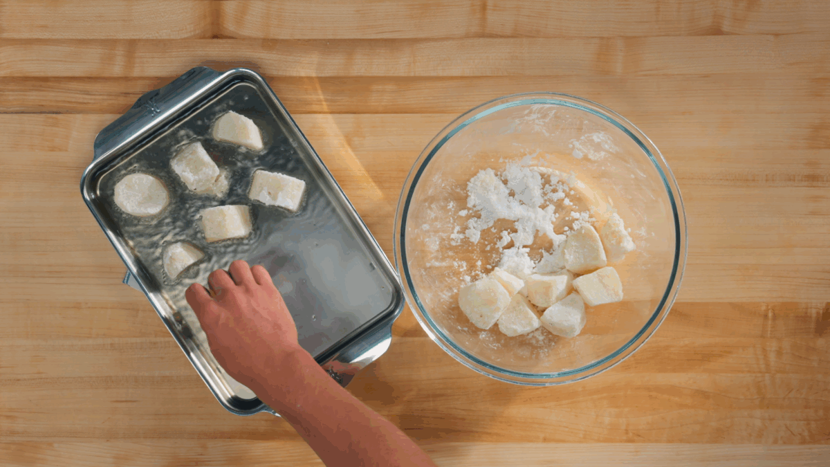Nick DiGiovanni placing potato pieces on a pan of hot oil. 