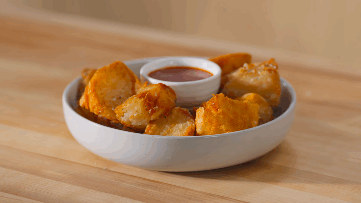 A bowl of crispy roasted potatoes. 