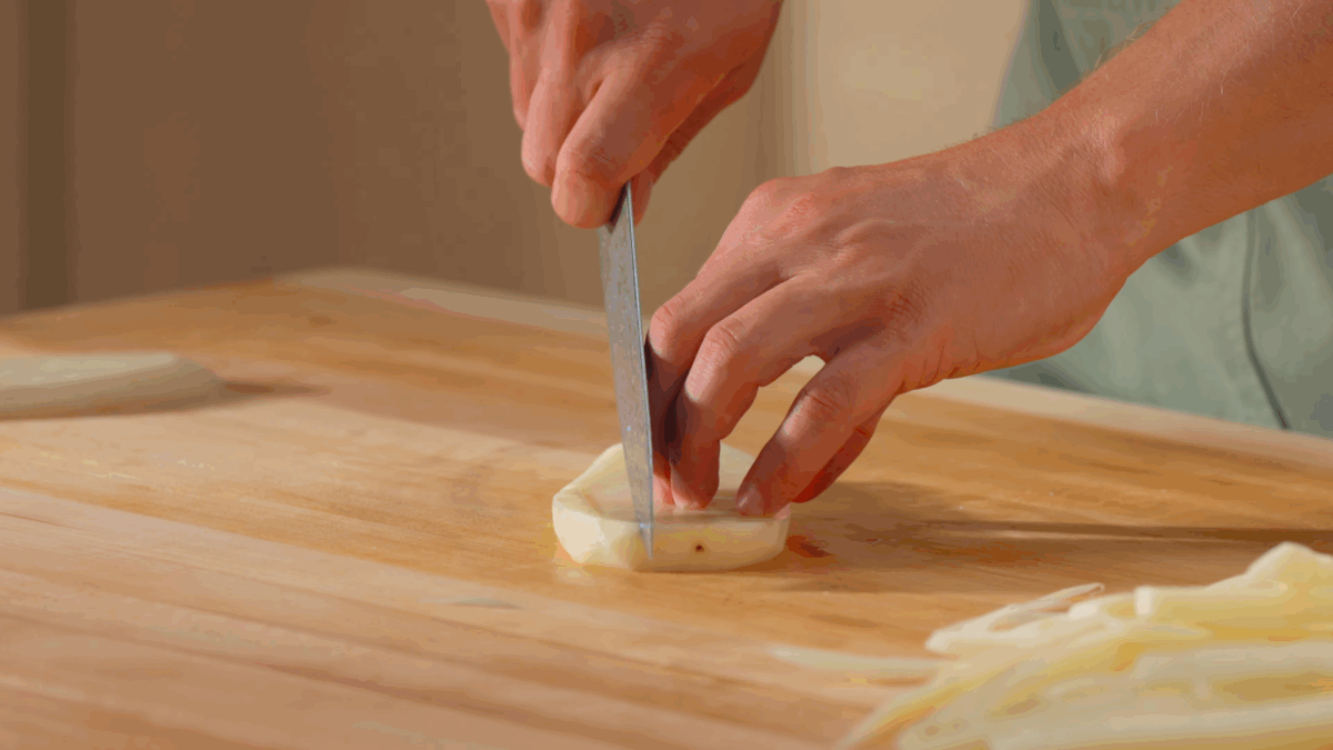 Nick DiGiovanni slicing a potato into fries.