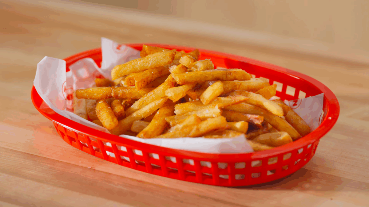 A basket of homemade crispy French fries.