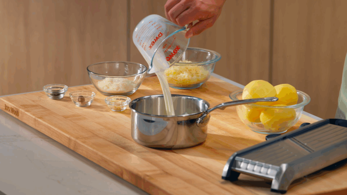 Nick DiGiovanni combining cream sauce ingredients in a pot. 