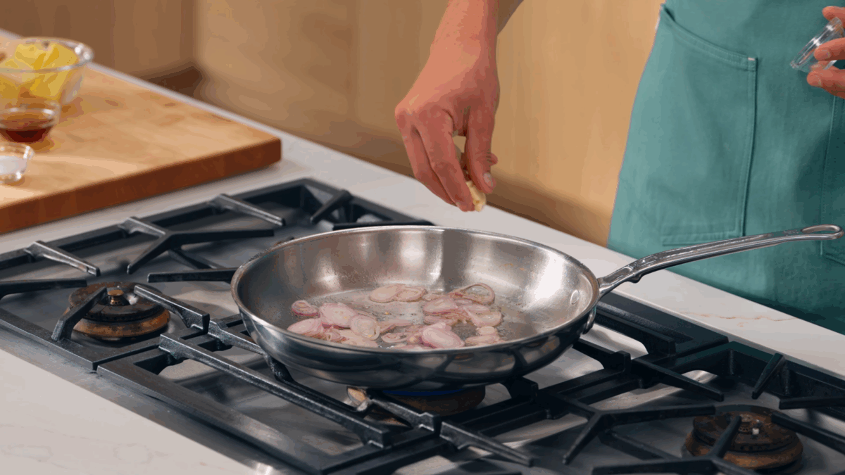 Nick DiGiovanni saut&eacute;ing shallots and garlic in butter and oil. 