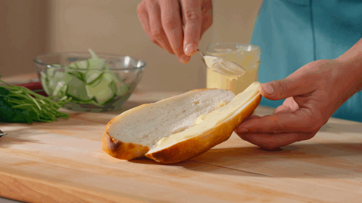 Nick DiGiovanni spreading Vietnamese mayo over a banh mi baguette. 