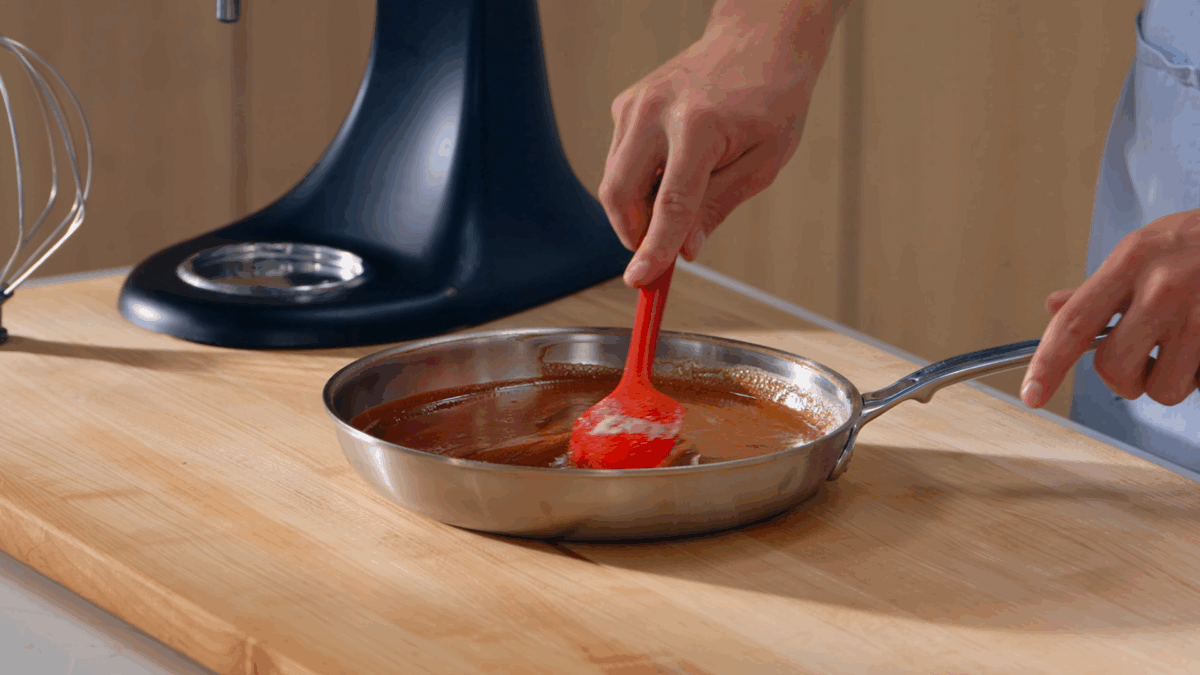 Nick DiGiovanni stirring melting chocolate into a skillet of brown butter. 