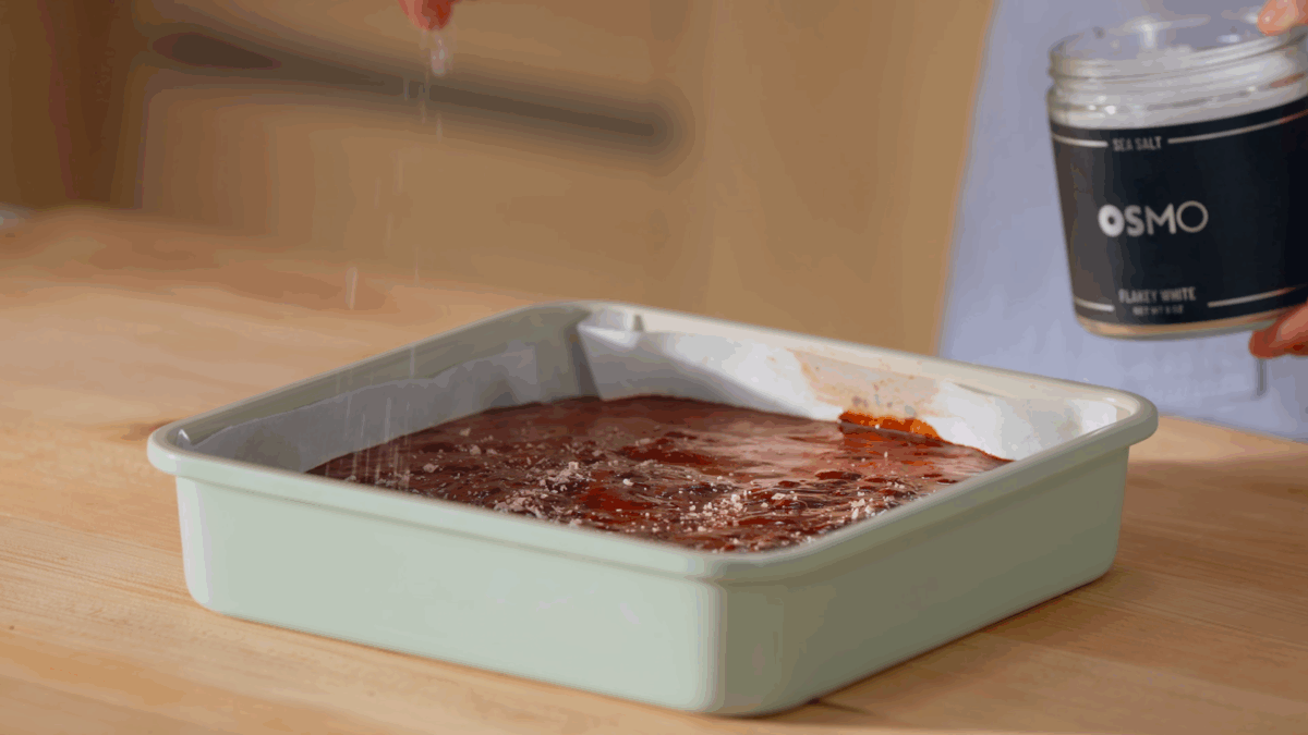 Nick DiGiovanni sprinkling OSMO flakey sea salt over a pan of brownie batter. 