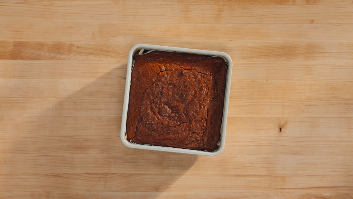 A square pan of homemade brownies on a counter. 