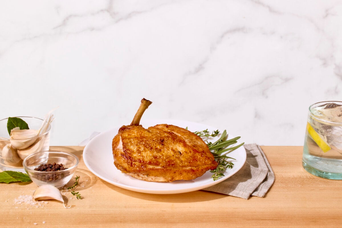 A brined and pan-roasted chicken. breast on a plate.