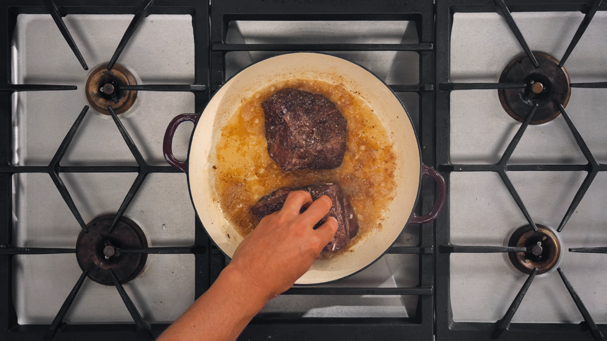 Nick DiGiovanni searing beef chuck in a Dutch oven.
