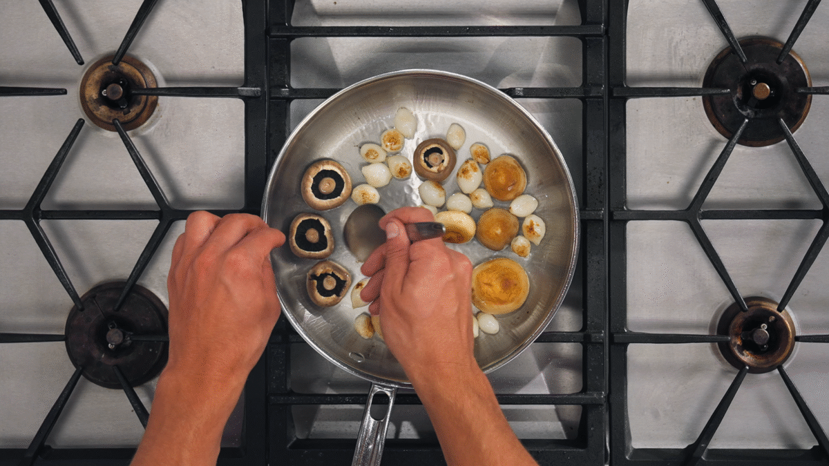 Nick DiGiovanni sautéing mushrooms and pearl onions.