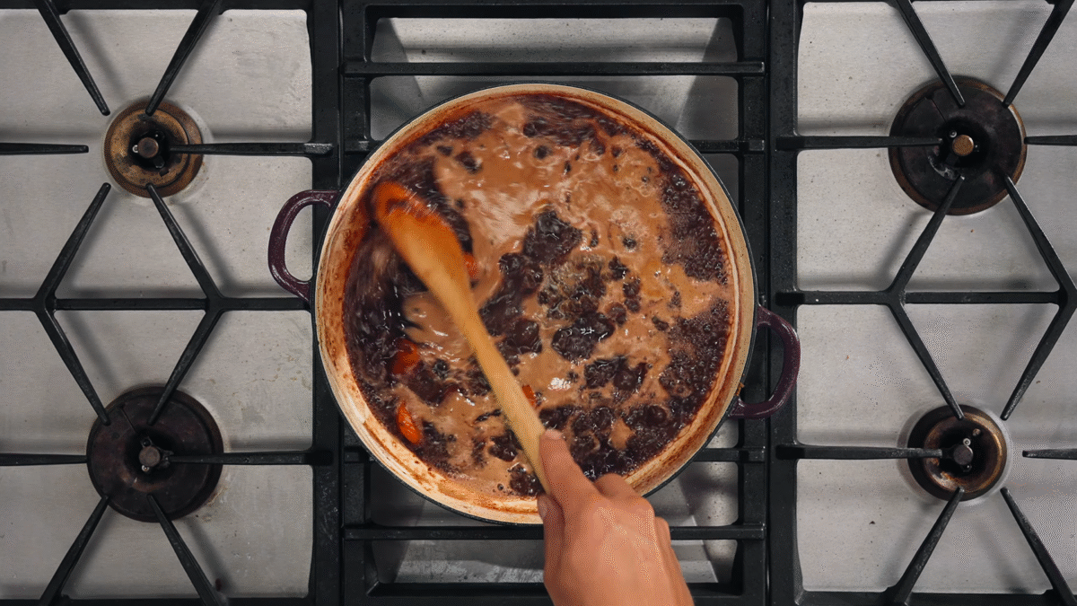 Nick DiGiovanni deglazing a pan.