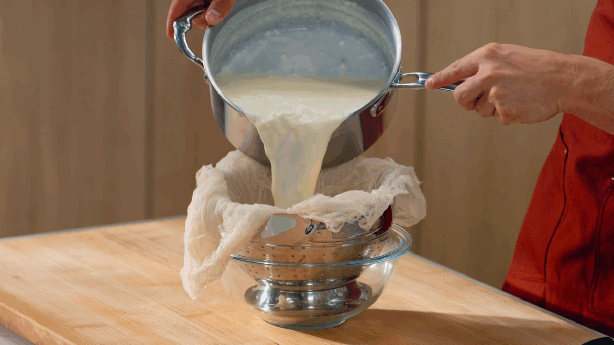 Nick DiGiovanni pouring mascarpone through a cheesecloth. 
