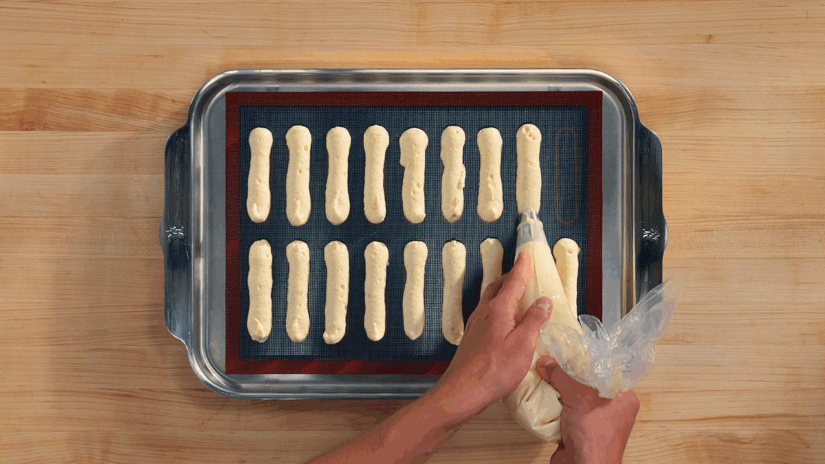 Nick DiGiovanni piping batter to make ladyfingers for homemade tiramisu. 