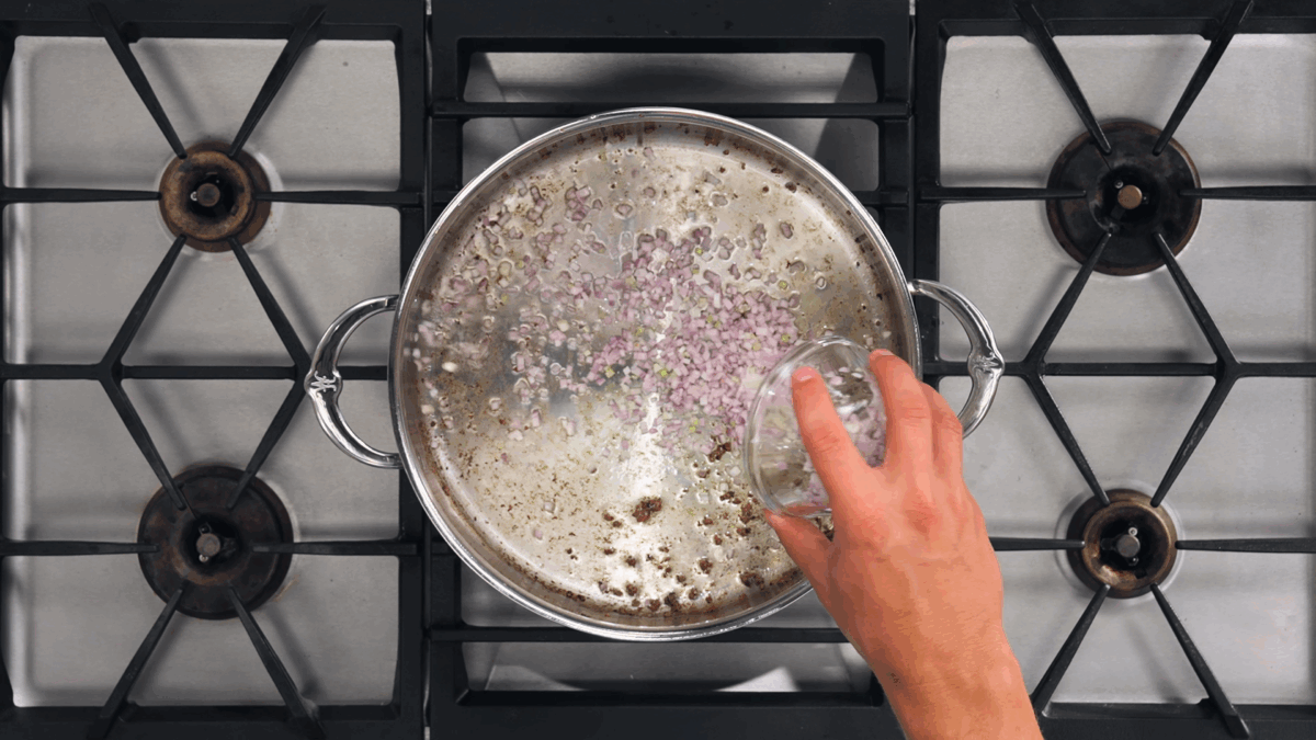 Nick DiGiovanni adding vegetables to a sauté pan.